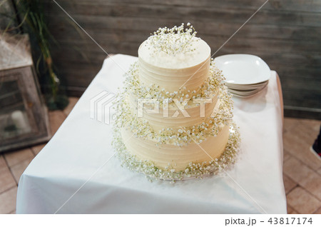 wedding cake three floors outside in the evening wedding cake three floors outside in the evening 43817174