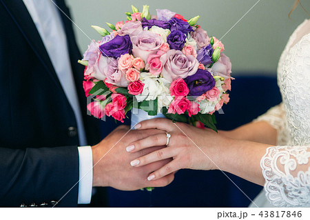 Weddin bouquet in newlyweds hands 43817846