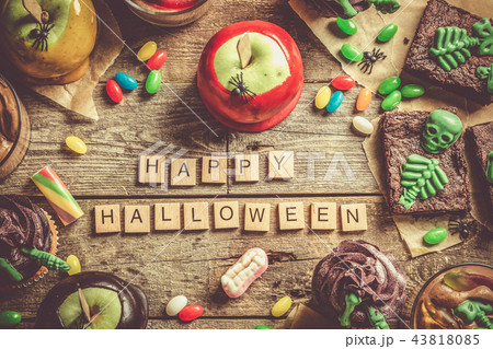 Selection of halloween party sweets - brownie, caramel apples, cupcakes, chocolate mousse, candies 43818085