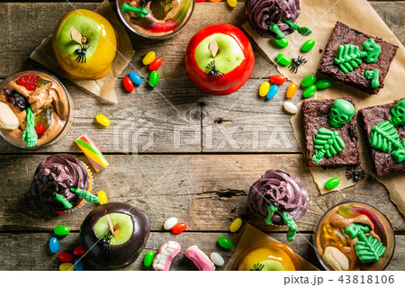 Selection of halloween party sweets - brownie, caramel apples, cupcakes, chocolate mousse, candies 43818106
