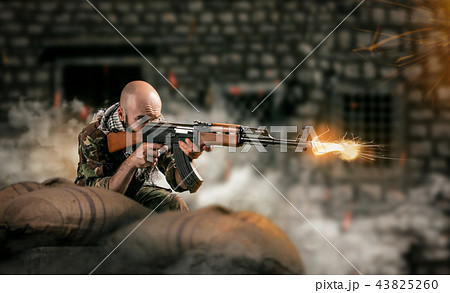 Terrorist sits in ambush and shoots from a rifle 43825260