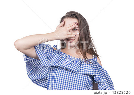 Woman is peeping through her fingers Woman is peeping through her fingers 43825526