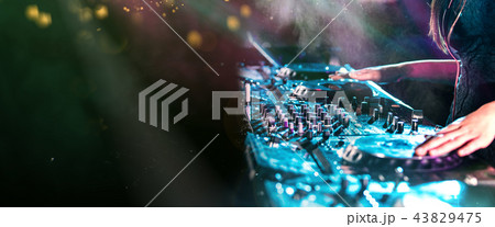 Dj mixes the track in the nightclub at a party Dj mixes the track in the nightclub at a party 43829475