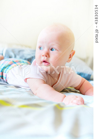 Cheerful baby boy in morning bedroom Child relaxing Cheerful baby boy in morning bedroom Child relaxing 43830534