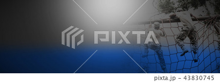 Military soldier climbing a net during obstacle course 43830745