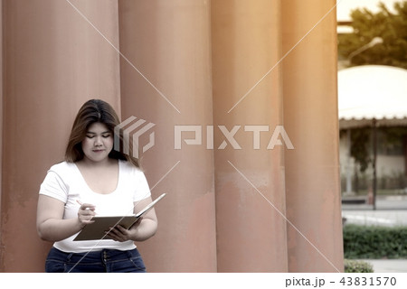 Pretty Asian fat women pose and thinking at a pole Pretty Asian fat women pose and thinking at a pole 43831570