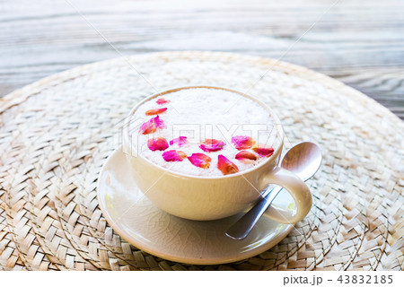 Cup pink cappuccino with foam decorated rose Cup pink cappuccino with foam decorated rose 43832185