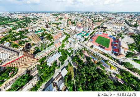 Aerial city view with crossroads and roads, houses, buildings, parks and parking lots. Sunny summer 43832279