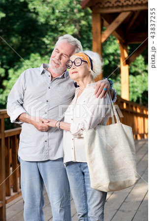 Aged people hugging and feeling good while standing together Aged people hugging and feeling good while standing together 43837255