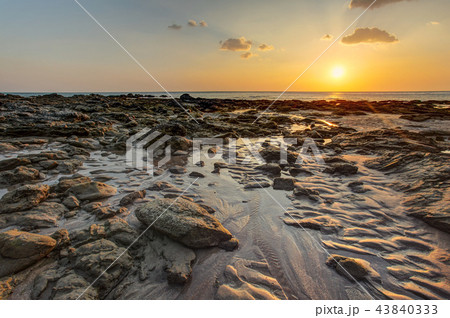 Beach in golden sunset light during low tide Beach in golden sunset light during low tide 43840333
