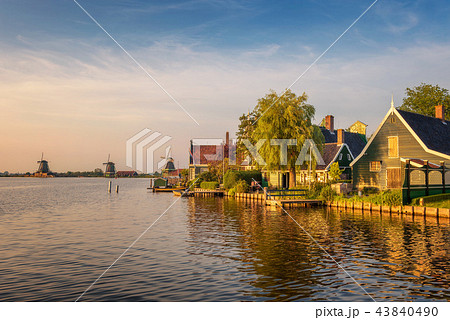 Sunset above farm houses and windmills of Zaanse Schans in Holland 43840490