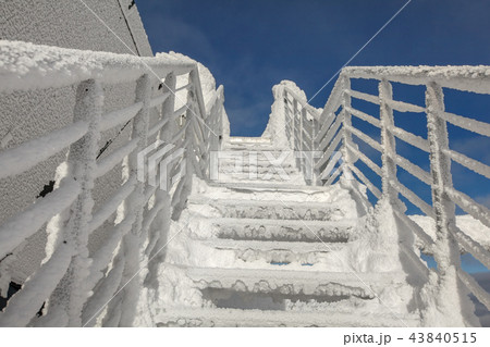 Snow and ice covered stairs and windows Snow and ice covered stairs and windows 43840515