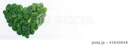 Heartshaped sign made of green spinach leaves 43840648