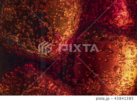 A glass with ice and cola. 43841385