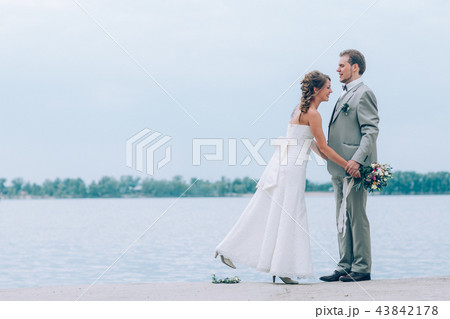 young groom and bride standing hugging young groom and bride standing hugging 43842178
