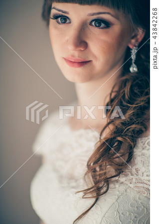 portrait of a young bride smiling and standing  43842268