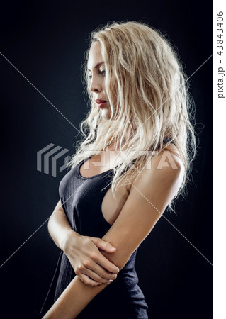 Portrait of beautiful young blond woman on black 43843406