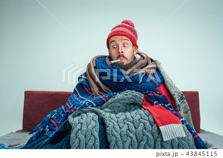Bearded Man with Flue Sitting on Sofa at Home. Healthcare Concepts. 43845115