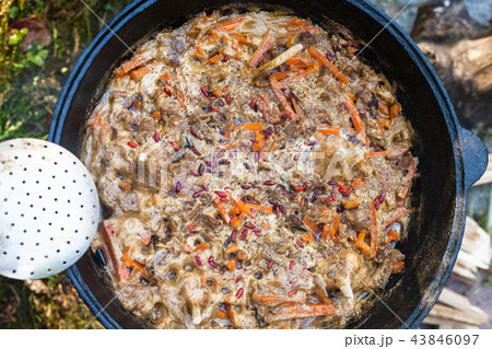 cooking central asian dish plov in kazan pot cooking central asian dish plov in kazan pot 43846097