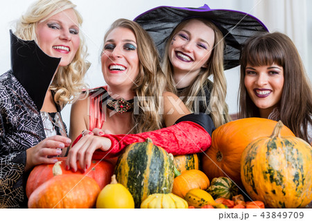 Four cheerful women celebrating Halloween together Four cheerful women celebrating Halloween together 43849709