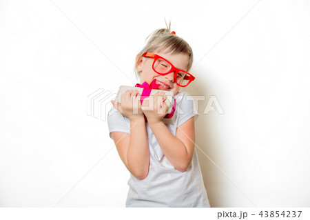toddler girl in glasses with gift box toddler girl in glasses with gift box 43854237