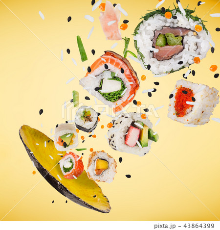Pieces of delicious japanese sushi frozen in the air. Pieces of delicious japanese sushi frozen in the air. 43864399