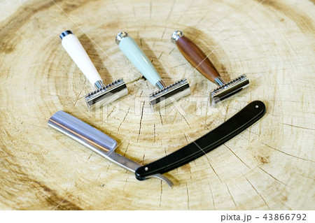 Three traditional steel razors with a brown handle made of valuable wood, bone, natural green stone Three traditional steel razors with a brown handle made of valuable wood, bone, natural green stone 43866792