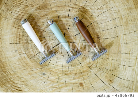 Three traditional steel razors with a brown handle made of valuable wood, bone, natural green stone 43866793