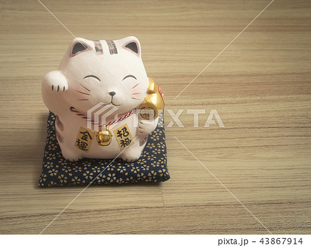 Lucky cat on wood background. Lucky cat on wood background. 43867914