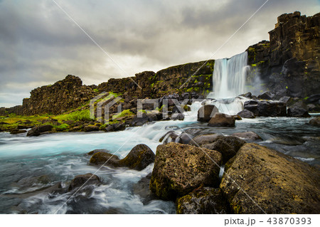 A waterfall in a beautiful Iceland landscape. 43870393