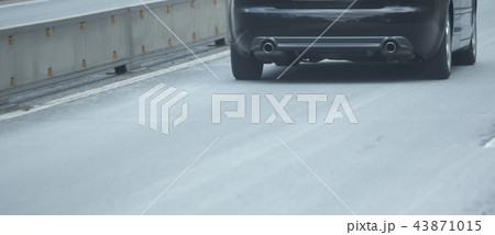 Rear and exhaust of a car on the highway 43871015
