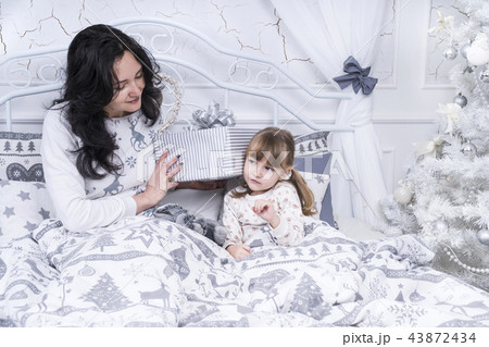 Child listens to a box with gift 43872434