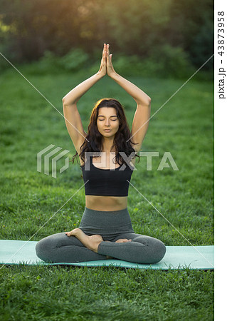 Young girl doing yoga in the park Young girl doing yoga in the park 43873958