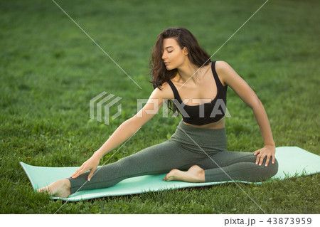 Young woman doing workout for stretching body. Young woman doing workout for stretching body. 43873959