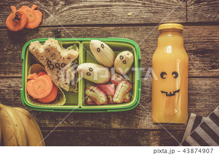 Halloween style school lunch box - ghost sandwich, pumpkin carrots, bananas, juice Halloween style school lunch box - ghost sandwich, pumpkin carrots, bananas, juice 43874907