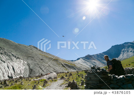 A helicopter in the sky above the mountains. A helicopter in the sky above the mountains. 43876105
