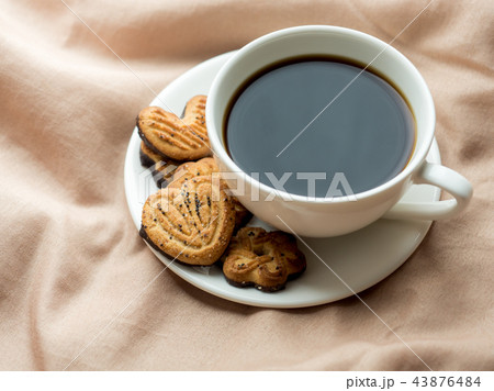 Cup of coffee with homemade cookies on the bed  Cup of coffee with homemade cookies on the bed  43876484