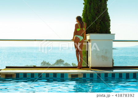 sexy girl by the pool overlooking the ocean 43878392