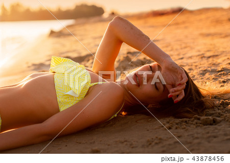 young sexy girl at sunset at the beach young sexy girl at sunset at the beach 43878456
