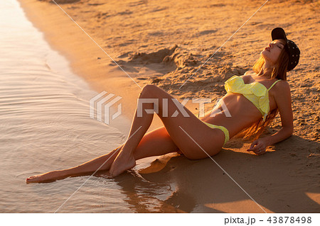 young sexy girl at sunset at the beach 43878498