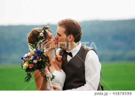 portrait of the bride and groom with a bouquet portrait of the bride and groom with a bouquet 43878599