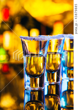 stack of tequila with salt close up on blurred  43879885