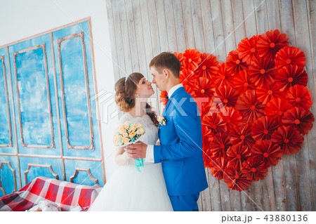 young groom kissing the bride in a studio interior 43880136