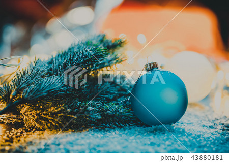 Blue Christmas tree ball next to the branch 43880181