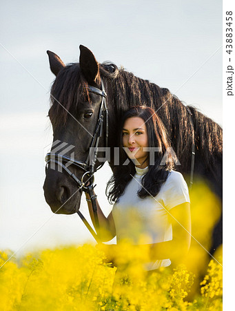 Young Woman with her horse at sunrise. Young Woman with her horse at sunrise. 43883458