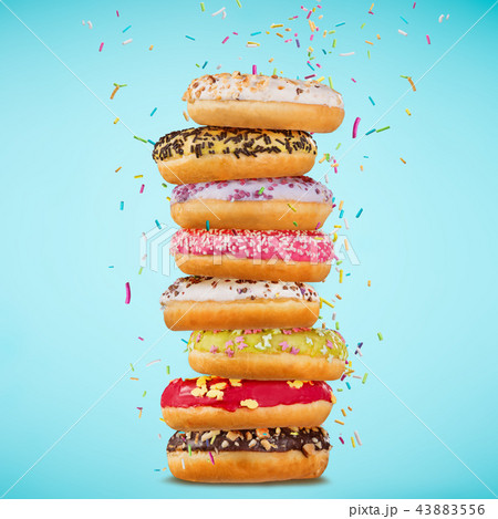 Tasty doughnuts on pastel blue background. 43883556