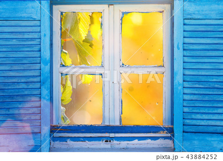 Beautiful vintage Greek window with blue shutters. Typical Greek picture. Beautiful vintage Greek window with blue shutters. Typical Greek picture. 43884252