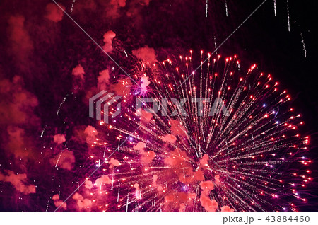 Very cheap firework over the city, red Very cheap firework over the city, red 43884460