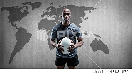 Rugby player holding ball with world map Rugby player holding ball with world map 43884676