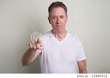 Portrait of mature man with gray hair against white background Portrait of mature man with gray hair against white background 43886918